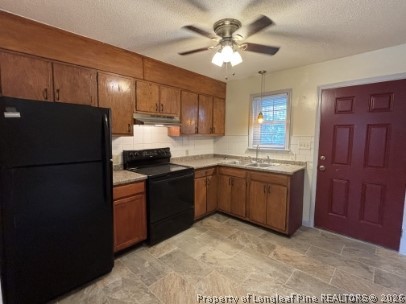 816 Shaw Mill Road, Unit 13 Fayetteville, NC 28311 - Photo 2 of 9 a kitchen with a refrigerator sink and cabinets