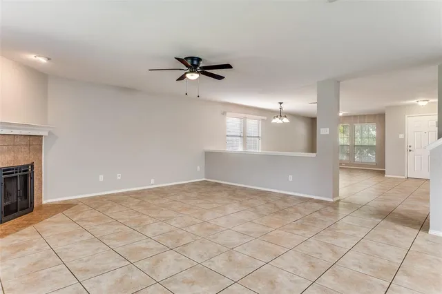 a view of an empty room and a kitchen