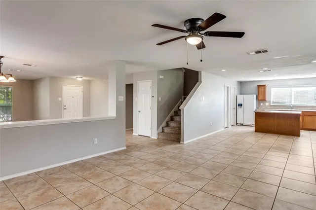 a view of a livingroom with a ceiling fan and window
