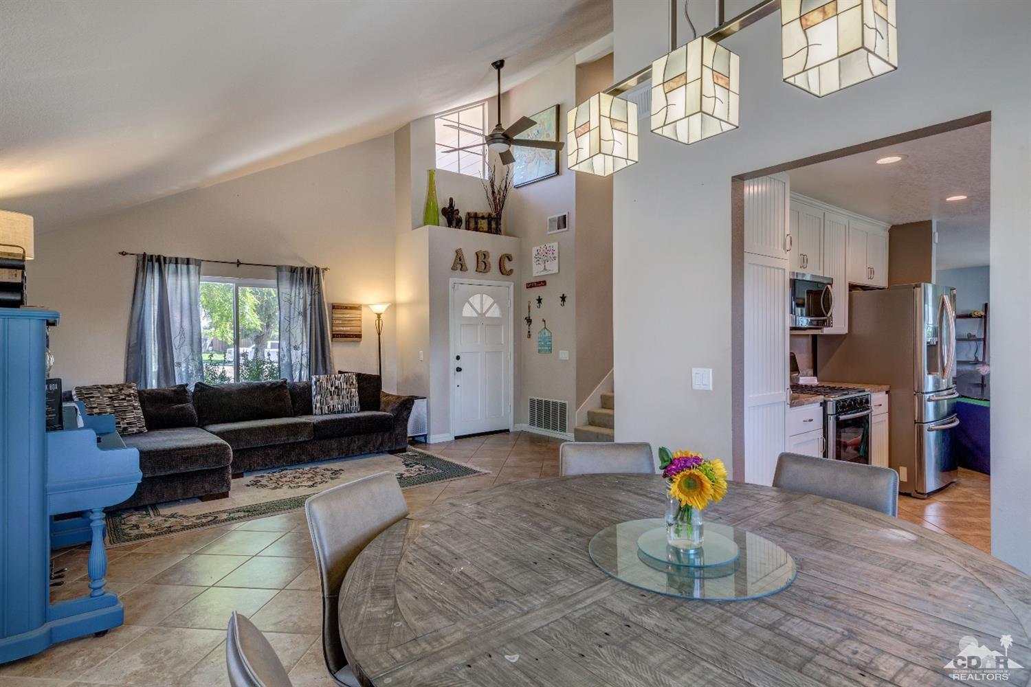 9043 Dancy Circle Riverside, CA 92508 - Photo 14 of 35 a living room with furniture kitchen view and a chandelier