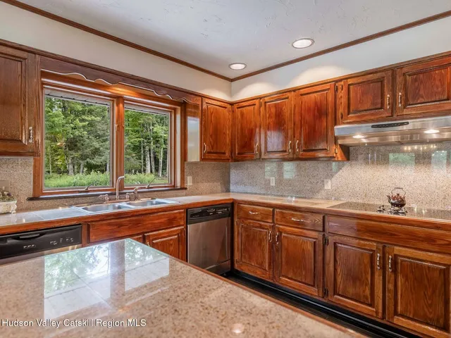 a view of a kitchen with furniture and wooden floor