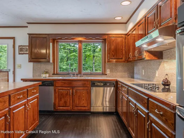 a living room with furniture wooden floor and a large window