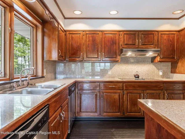 a kitchen with stainless steel appliances granite countertop a stove and a refrigerator