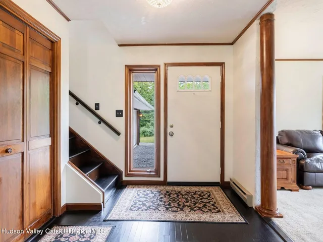 a living room with furniture and wall painting
