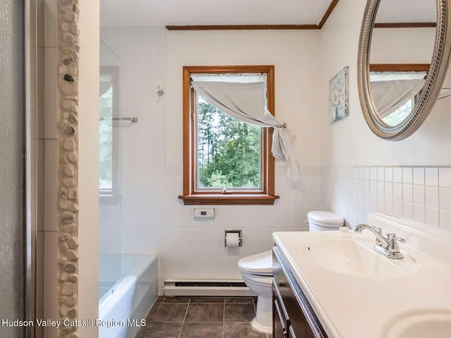 a bedroom with a large bed and a window with the outer view