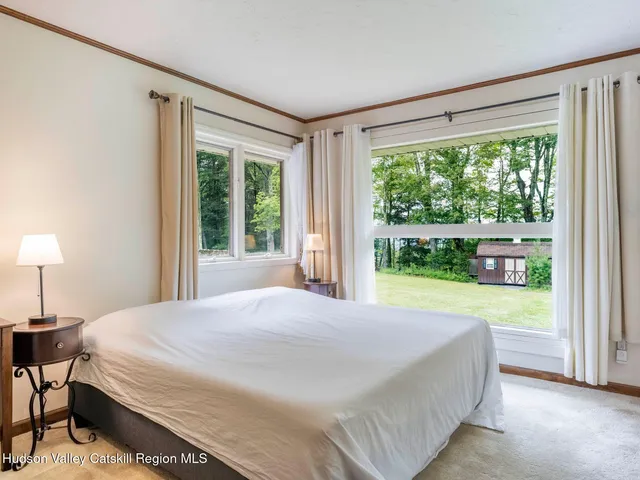 a bedroom with a bed and a chair