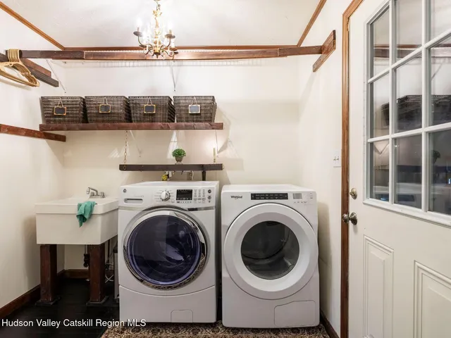 a view of a yard in front of a house with large tree