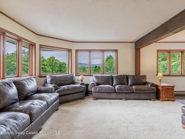 a dining room with furniture a chandelier and wooden floor