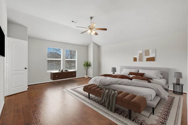 a spacious bedroom with a bed and a window