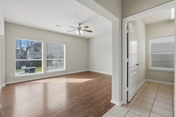 wooden floor in an empty room with a window