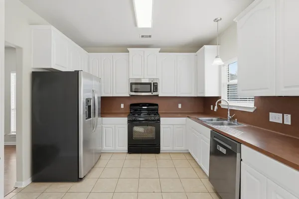 a kitchen with a sink a stove and refrigerator