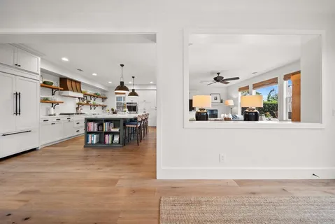 a view of a hallway with wooden floor