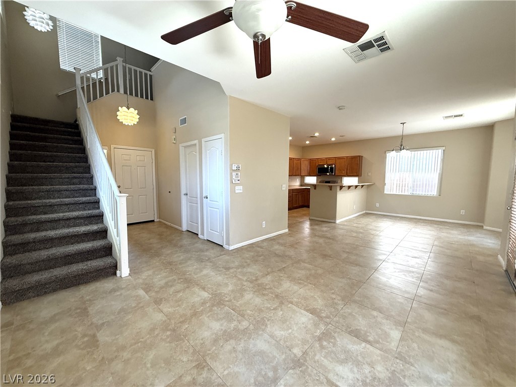 5942 Rampolla Drive Las Vegas, NV 89141 - Photo 2 of 27 A spacious, open-concept living area with integrated kitchen and convenient staircase access.