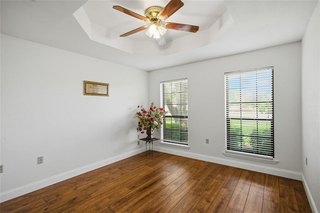 265 East Dove Road Southlake, TX 76092 - Photo 22 of 39 an empty room with wooden floor and windows