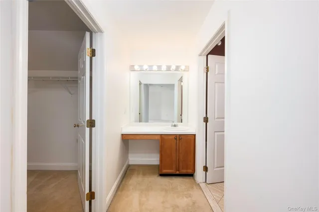a view of bathroom with a sink and mirror