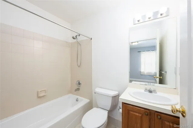 a bathroom with a sink toilet vanity and bathtub