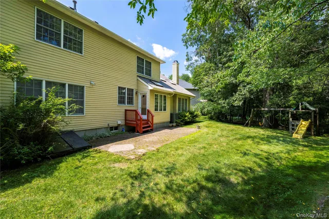 a view of a house with backyard and sitting area