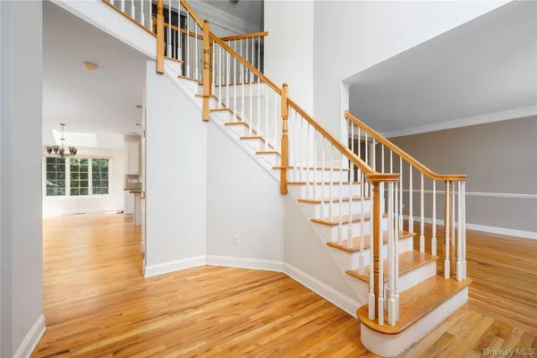 a view of entryway with wooden floor and stairs