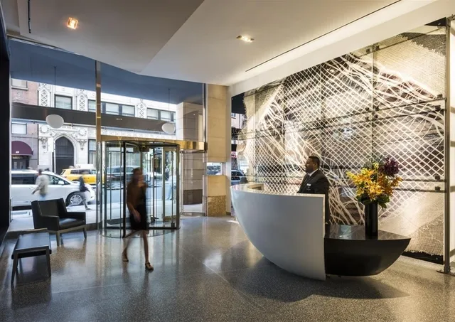 a living room with a large window and furniture