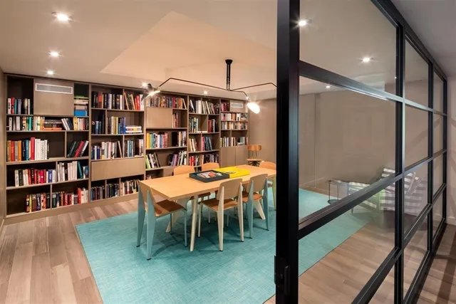 a dining room with furniture and a book shelf