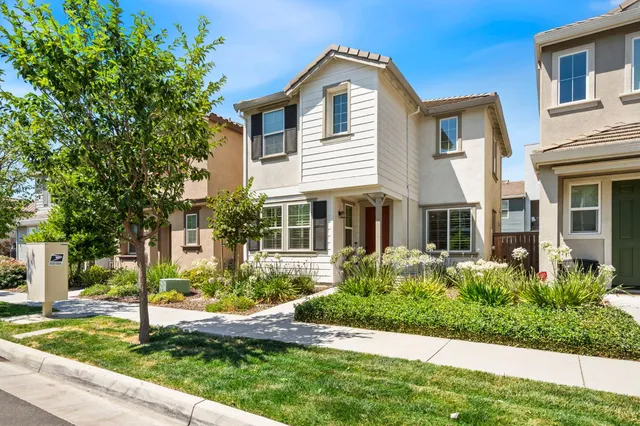 a front view of a house with a yard