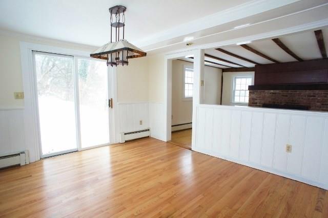 a view of a hallway with wooden floor and a ceiling fan
