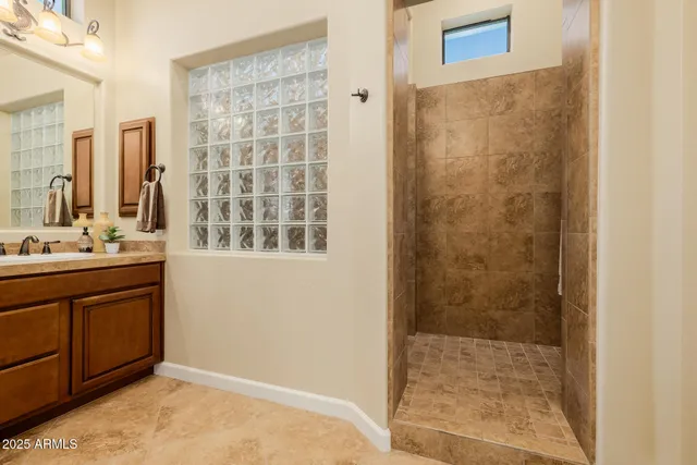 a view of swimming pool with outdoor seating and house in the background