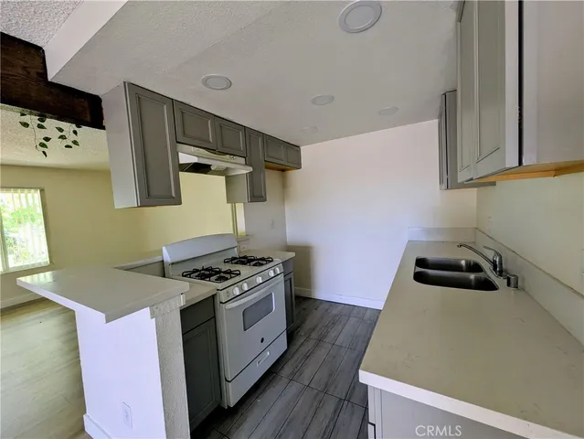 a kitchen that has a sink and a stove