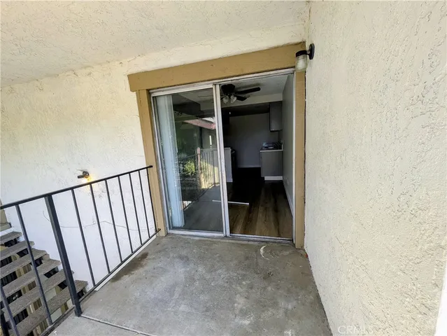 a view of a hallway to rooms
