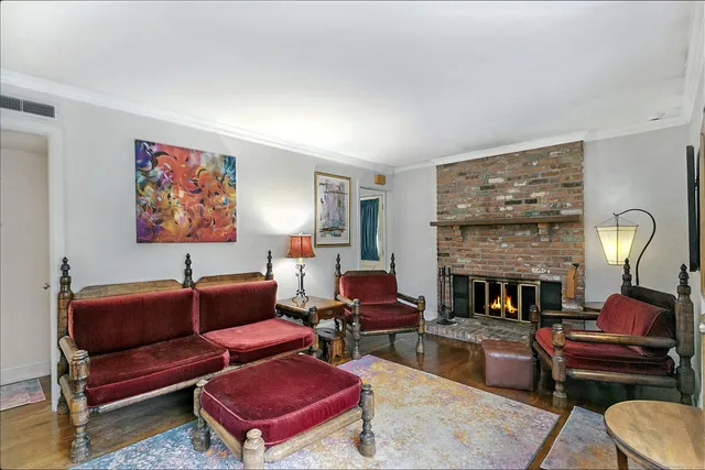 a living room with furniture fireplace and rug