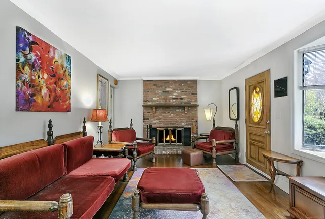 a living room with furniture fireplace and large window