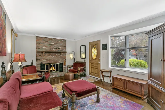 a living room with furniture a flat screen tv and a floor to ceiling window