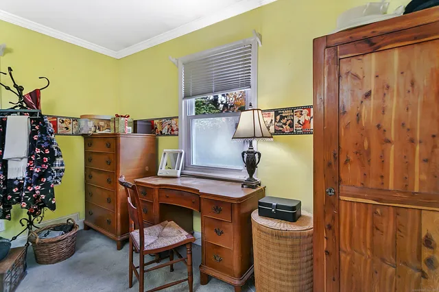 a balcony with furniture and a potted plant