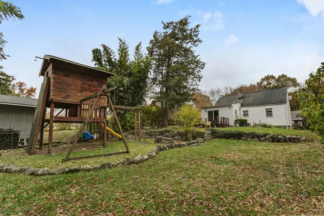 a front view of house with yard and trees