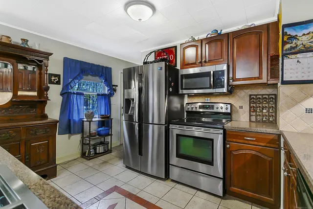 a kitchen with a stove a microwave and refrigerator