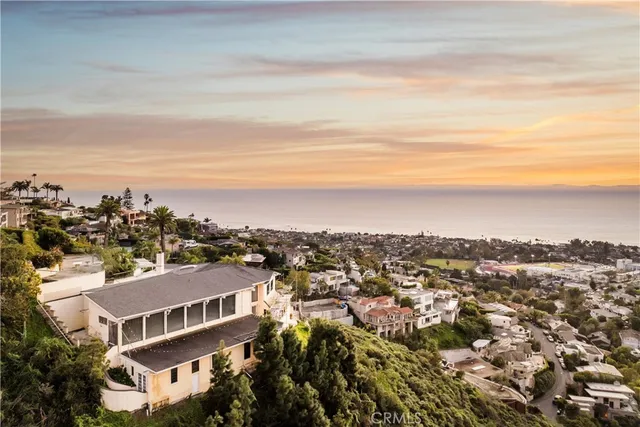 an aerial view of residential houses with city view