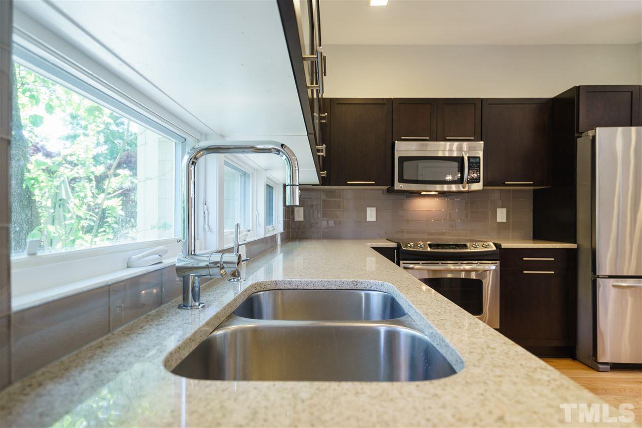 2514 Colton Place Raleigh, NC 27609 - Photo 11 of 25 a kitchen with a sink stove and refrigerator