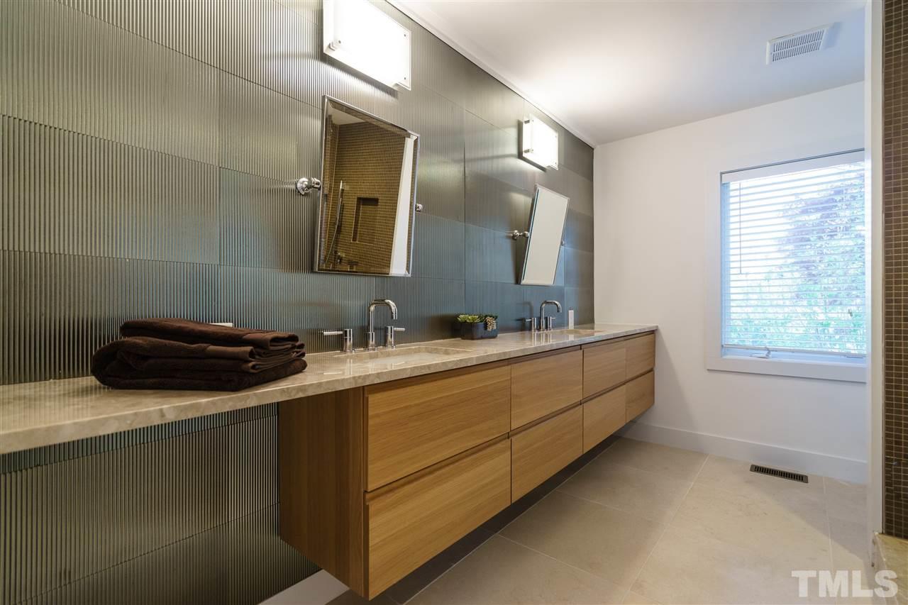 2514 Colton Place Raleigh, NC 27609 - Photo 17 of 25 a bathroom with a sink and a mirror