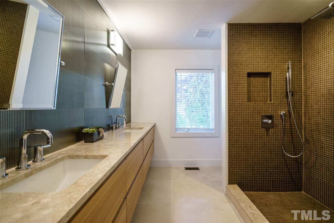2514 Colton Place Raleigh, NC 27609 - Photo 19 of 25 a bathroom with a sink and mirror with shower