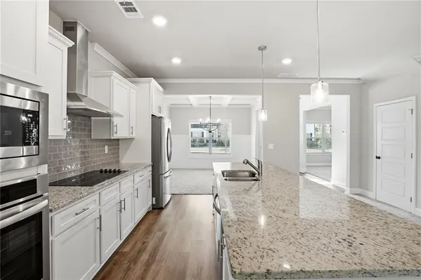 a large white kitchen with lots of counter space and glass door