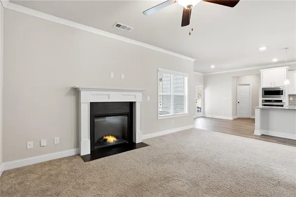 a view of an empty room with a fireplace and a window