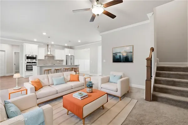 a living room with furniture and a view of kitchen