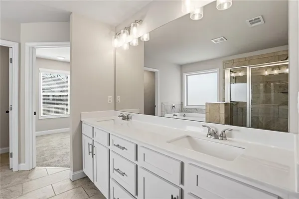 a bathroom with double sink and a mirror