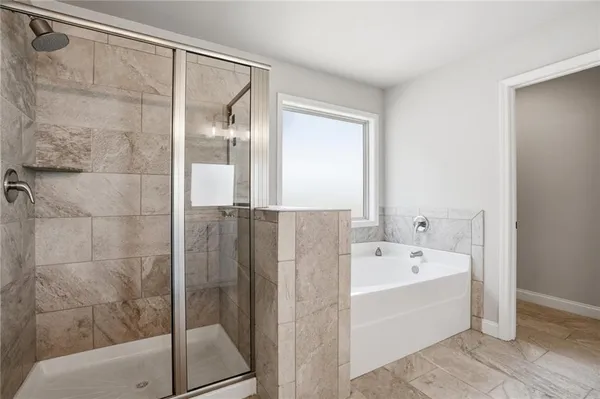 a bathroom with a bathtub and a shower