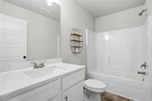 a bathroom with a sink a toilet and a bathtub