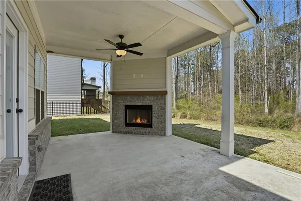 a view of an empty room with a fireplace and a yard
