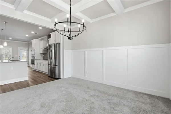 a view of a kitchen with a sink and stainless steel appliances