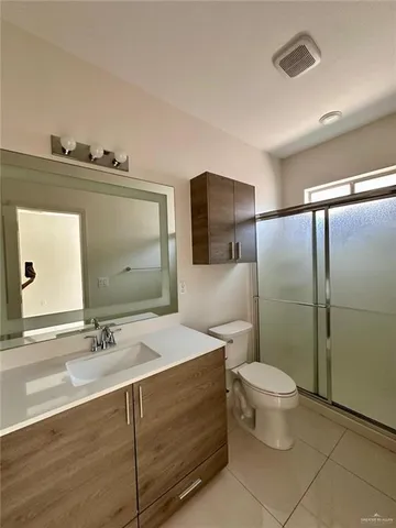 a bathroom with a sink toilet and mirror