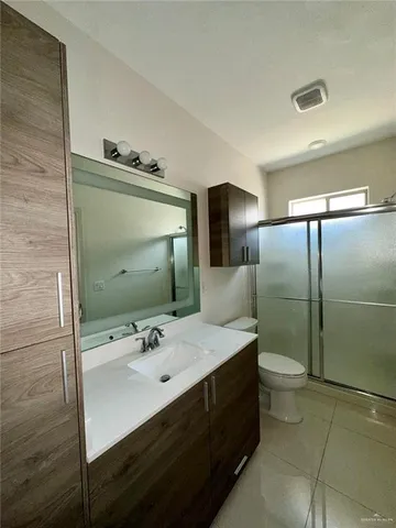 a bathroom with a sink toilet and mirror