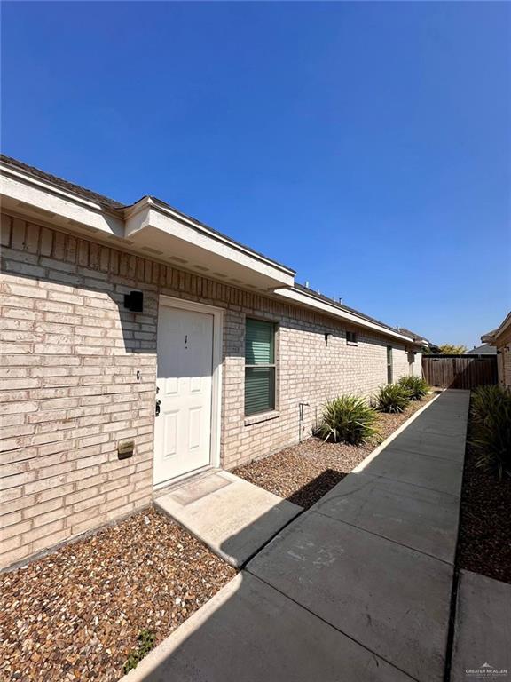 5700 Nightingale Avenue, Unit 1 Mission, TX 78573 - Photo 19 of 21 a front view of a house with a yard